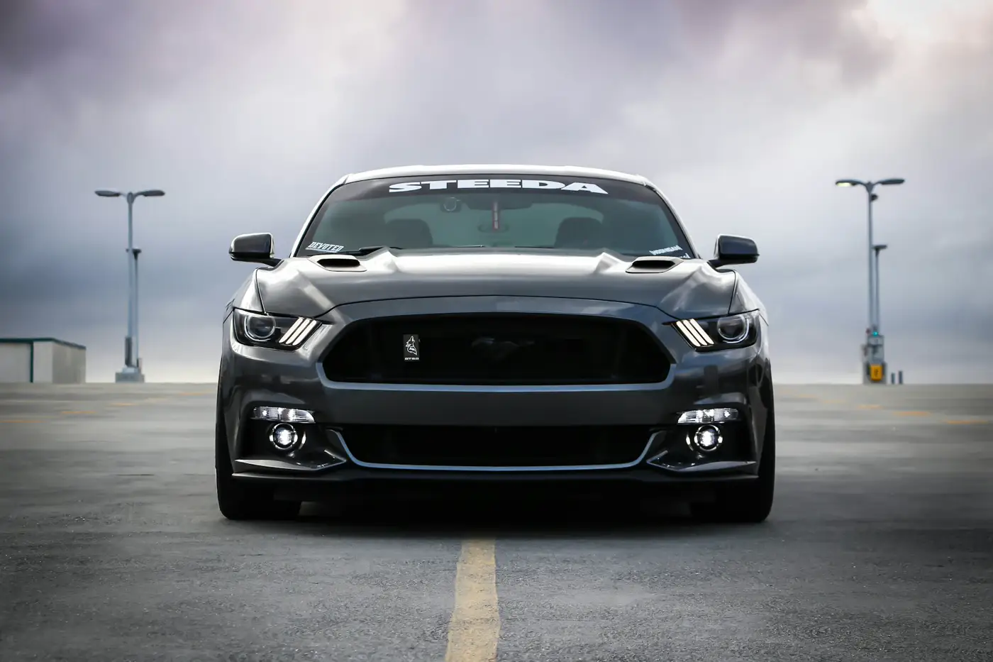 Illustrative photo of a black car on a road. Not a West Auto paint job.