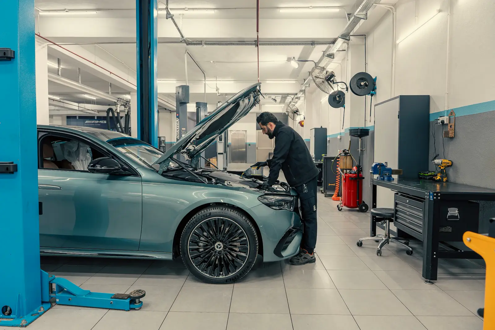 Illustrative photo of a mechanic under a raised car. Not the West Auto workshop and not their staff.